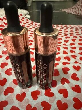 Revolution Bronze Gold Liquid Highlighter Duo with Rose Gold Caps both bottles
